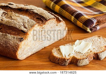 Rustic bread with bran close-up. Healthy whole wheat bread with crispy crust