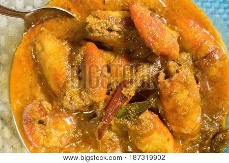 Orange coloured Prawns cooked and served in a bowl Indian delicacy food - called 