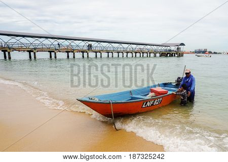 Labuan,Malaysia-Feb 19,2017:Traditional fisherman with fishing boat in beach of Papan island at Labuan Pearl of Borneo,Malaysia.