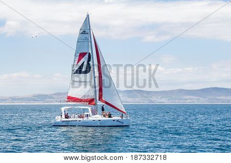 CAPE TOWN SOUTH AFRICA - 19 December 2016: Bridgestone charter sailing catamaran yacht Ameera outside Cape Town harbour with tourists on board - Illustrative Editorial Image