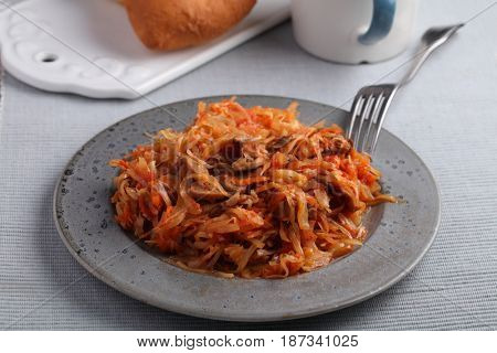Mushroom bigos and cabbage pies on a rustic table