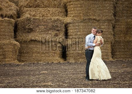 A Picture Of A Couple Hugging Each Other In The Front Of Haycocks