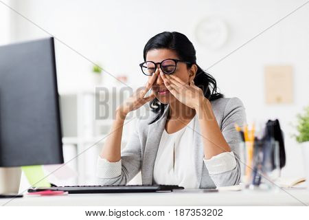 business, overwork, deadline, vision and people concept - tired businesswoman in glasses working at office and rubbing eyes