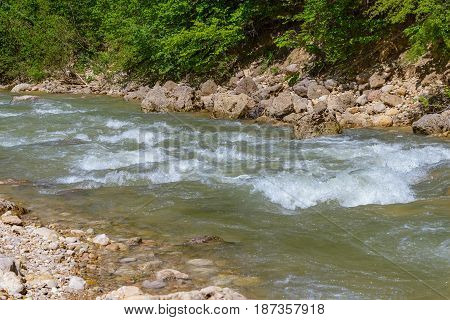 Mountain river flowing among the stone coasts