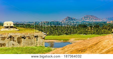 View from Hemakuta hill sunset point with ancient ruins, Hampi, Karnataka, India. Landscape with unique mountain formation with amazing stones tropical nature and temple. UNESCO World Heritage Site