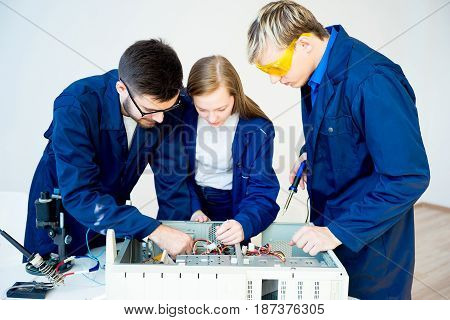 Team of IT specialists repairing broken computers