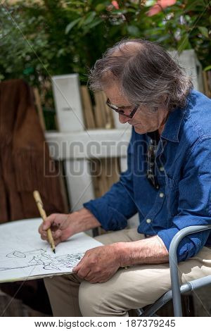 Paris, France - May 12, 2017: An artist painting on Place du Tertre in Montmartre district in Paris