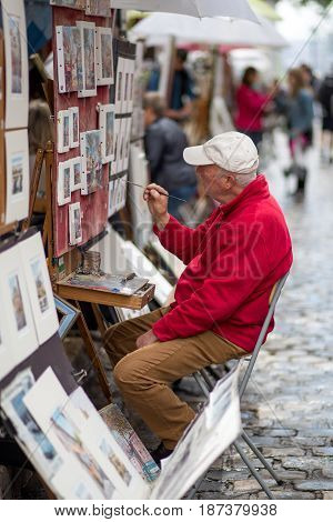 Paris, France - May 12, 2017: An artist painting on Place du Tertre in Montmartre district in Paris