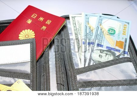 Close up of Passport and currency in black wallet