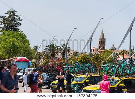 Alghero Italy - May 05 2017: 100th Giro d'Italia team cars with Alghero steeple on the background