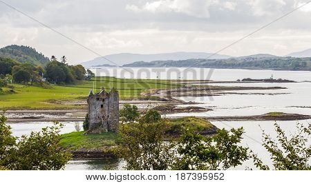 CASTLE STALKER ARGYLL AND BUTE SCOTLAND - SEPTEMBER 24 2014: panoramic view of the defensive tower and island surroundings during Loch Linnhe low tide. The fortress was built by clan MacDougall.