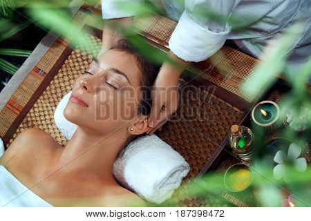 portrait of young beautiful woman relaxing in spa environment