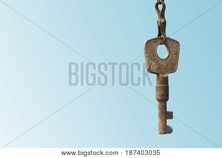 Vintage key on blue background. Copy space
