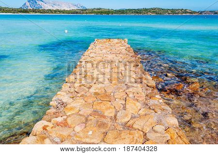 Stone pier in Brandinchi cove in Sardinia