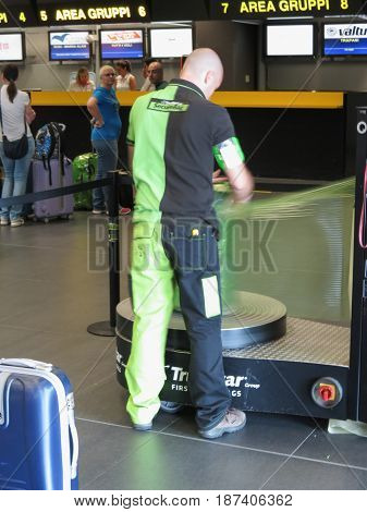 Luggage Wrapping With Plastic Sheet