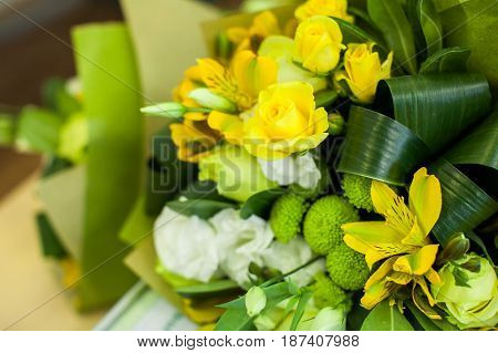 Green and yellow Flower composition on a table. Wedding decor. Beautiful bouquet of flowers.