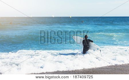 Surfer girl holding surfboard on background sea scape sand beach coastline. Panorama horizon perspective view ocean sunlight. Travel summer sport concept backdrop sunny waves seascape mock up