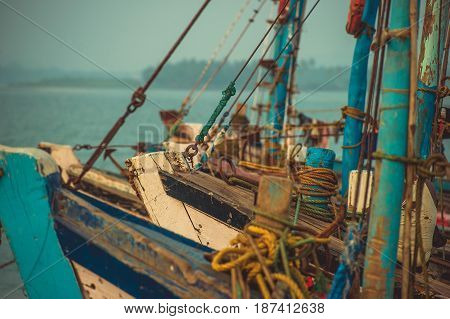 Noses of fishing boats standing on the dock in the background Arabian Sea.