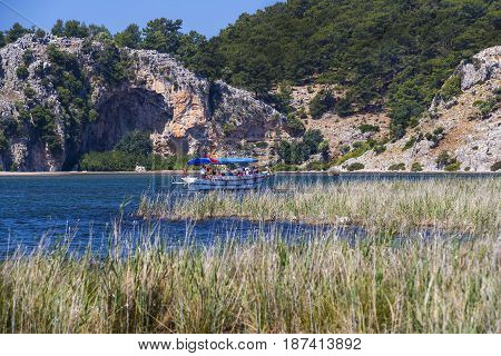 TURKEY, MUGLA ,DALYAN, - 5 MAY , 2017: The Dalyan River with tourist boats in the straits of the river