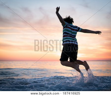 Happy boy enjoying the beach