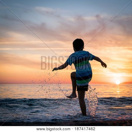 Happy boy enjoying the beach