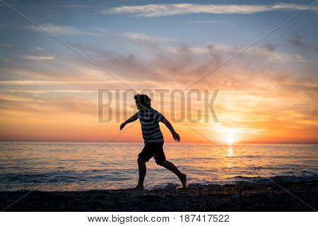 Happy boy enjoying the beach