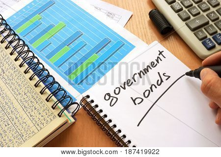 Government bonds written in a note. Trading concept.