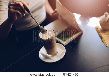 Woman Cafe Customer Mixing Caffe Latte With Spoon