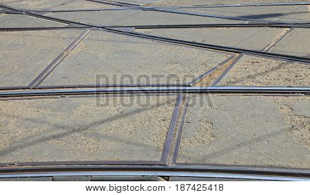Close-up of tram rails on an old broken city street.(Location:BucharestRomania)