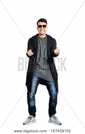 Casual young man wearing sunglasses, hands up, bent backwords, happy, positive attitude, full lenght, isolated on white