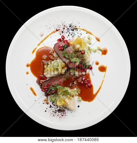 Venison fillet and potato puree, gourmet dish isolated on black background