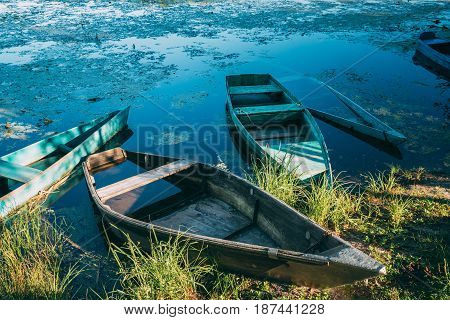 Abandoned Old Wooden Fishing Boats In Summer Lake Or River. Beautiful Summer Sunny Day Or Evening. Forsaken Boat. Russian Nature