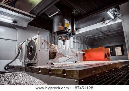 Metalworking CNC milling machine. Cutting metal modern processing technology. Small depth of field. Warning - authentic shooting in challenging conditions. A little bit grain and maybe blurred.