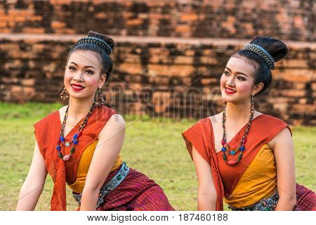 KALASIN THAILAND - FEBRUARY 20 2016: Girl dancers with local dress doing Thai Northeastern traditional dance at Yaku Pagoda to celebrate Buddism event in Kalasin