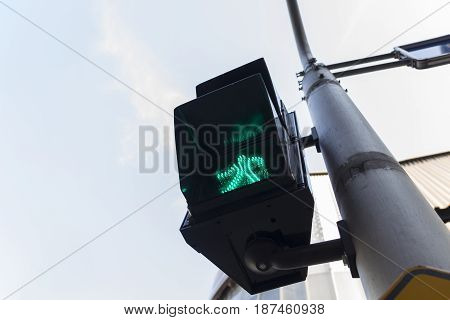 green light signal for pedestrian walk across crosswalk way