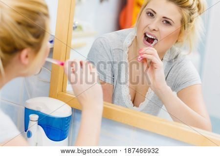 Woman Brushing Cleaning Teeth In Bathroom