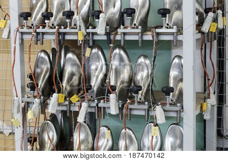 A rack with aluminum shoe pads. Modern footwear production.