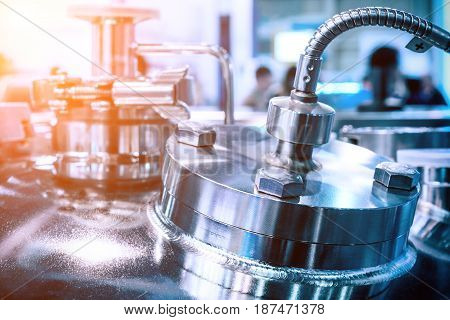 The steel case of the chemical reactor, chrome surfaces. Selective focus. Abstract industrial background, sunshine.