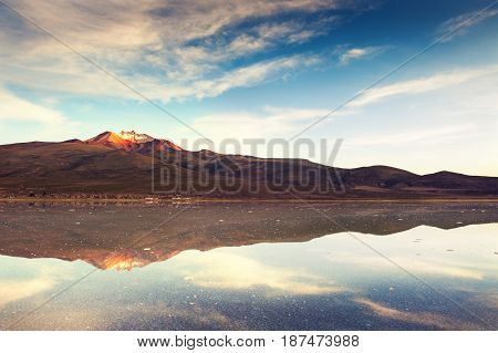 Salt Flat Salar De Uyuni And Volcano Tunupa At Sunrise, Bolivia