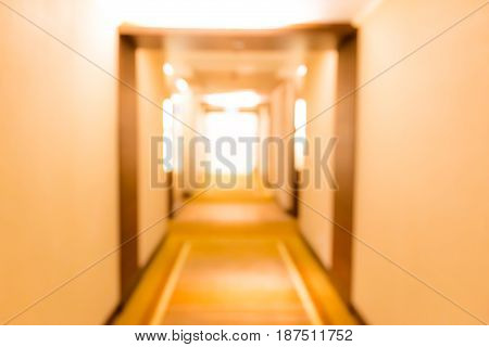 Abstract blurred background of hotel corridor and sunlight from windows in background.
