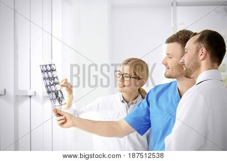 Group of doctors looking at roentgenogram in clinic