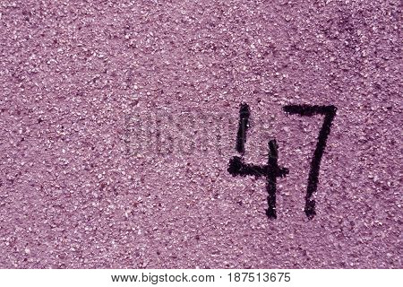 Number Fourty Seven On Purple Plaster Wall.