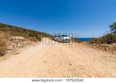 CRETE GREECE - JULY 11 2016: Cars are on a dirt road. Island Kalydon.