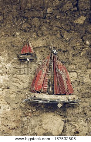 HERAKLION GREECE - JULY 16 2016: Sale of traditional local souvenirs in the historic center of the city. Wooden sailboat. Stylization. Toning.