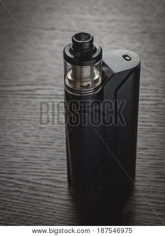 Black Vaporizer On The Brown Wooden Table