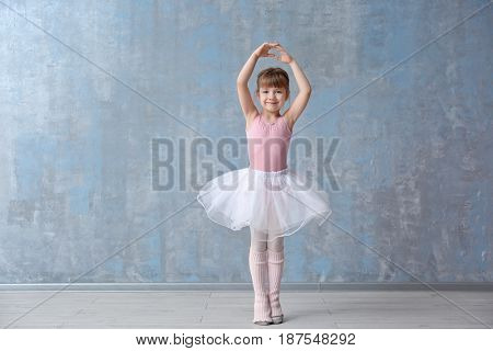 Cute little ballerina in dance studio