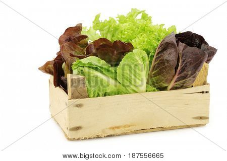 fresh romaine and red lettuce in a wooden crate on a white background