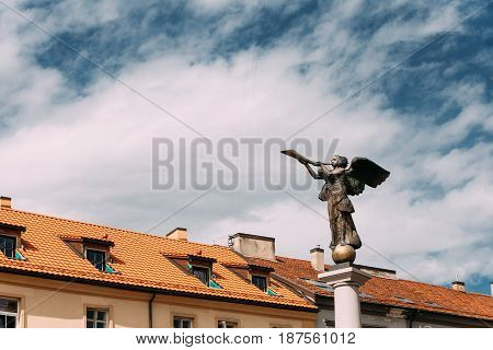 Vilnius, Lithuania. Statue Of An Angel Blowing A Trumpet In Main Square Against A Sunny Blue Sky In Uzupis District. Uzupio Republic Or Uzupis Is A Cultural Artistic District, Popular Tourist Place