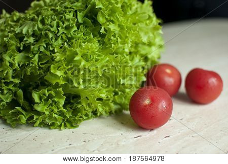 Bunch Of Raw Organic Green Frisee Salad And Two Tomatoes