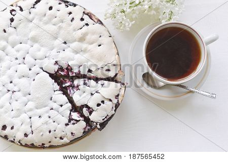 Tender homemade baking blueberry pie with lilac and tea